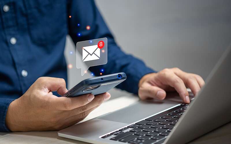 A man reviewing email on his phone.