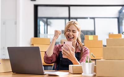 A female smiling after their merchant account approval.