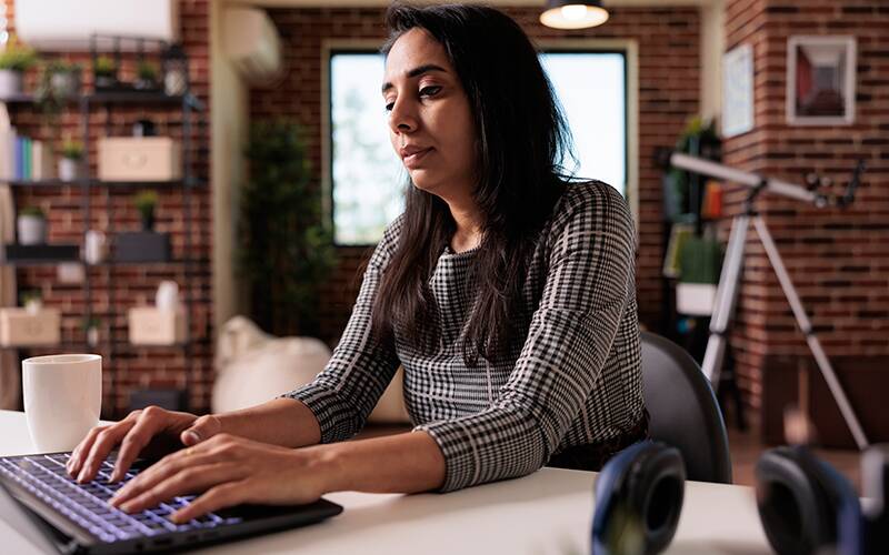 Image of a merchant typing at a keyboard.