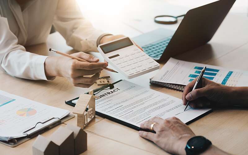 A merchant signs a contract, in this case a guarantee.